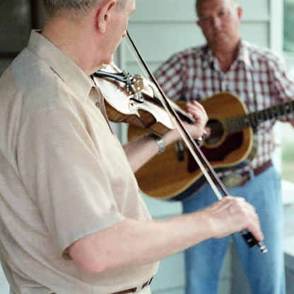 Two musicians playing violin facing each other