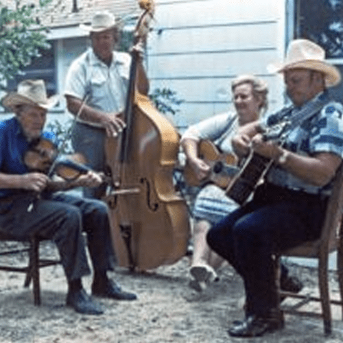 A group of people sitting around playing instruments.