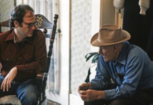 Two men sitting next to each other in a room.