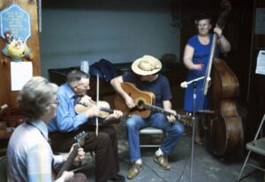 A group of people playing instruments in a room.
