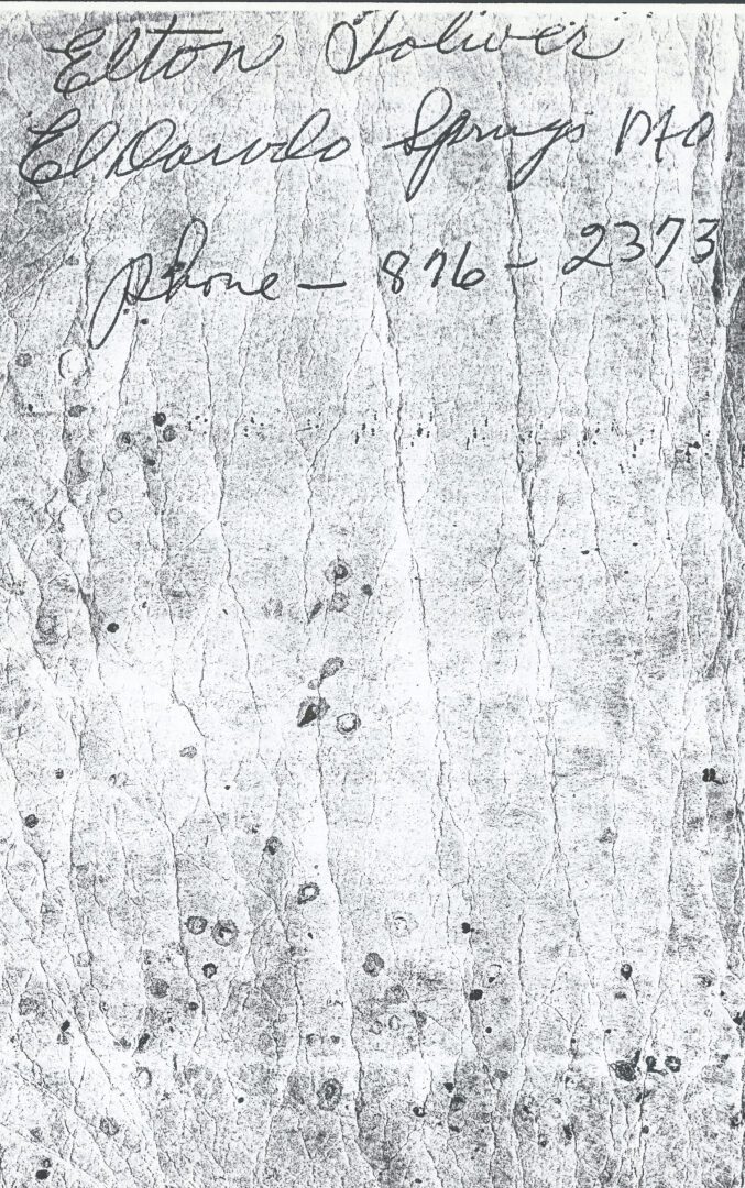 An old handwritten paper with a phone number