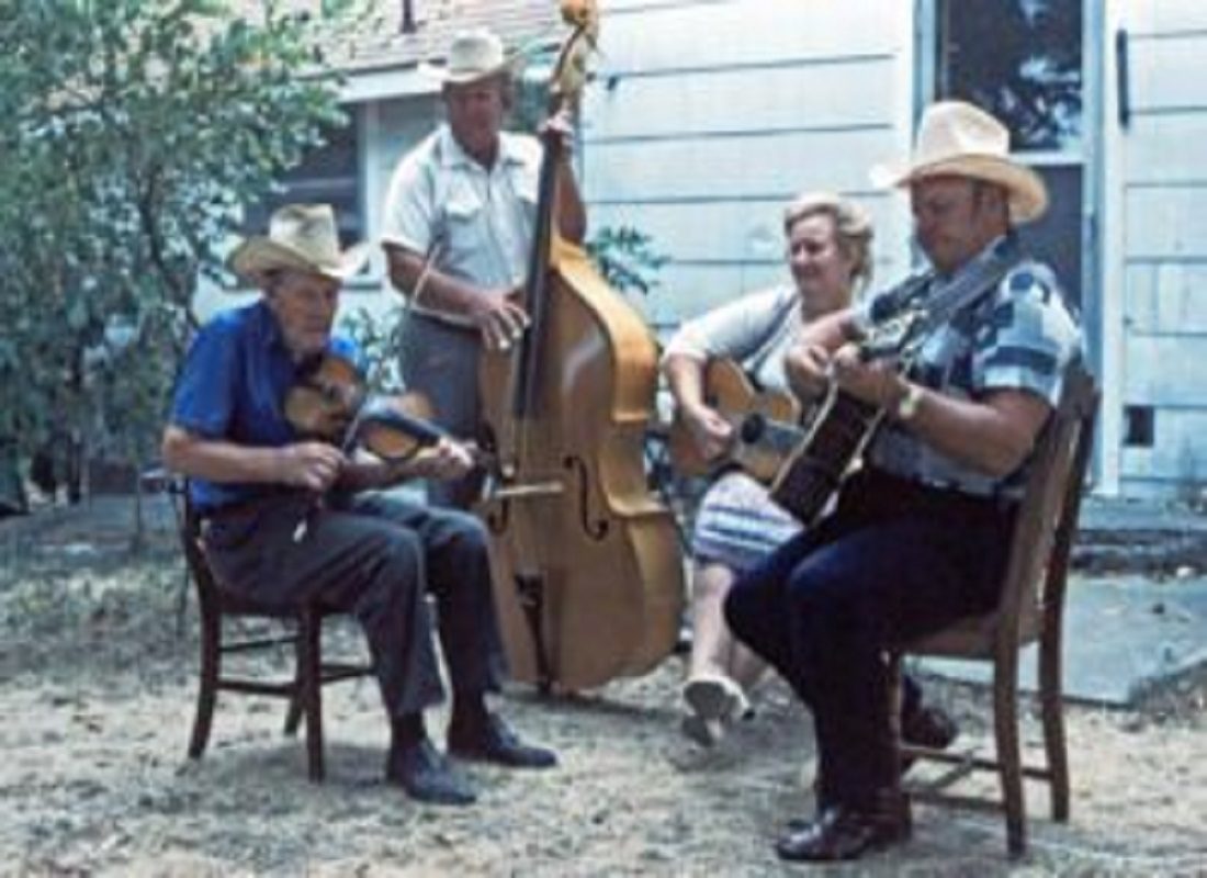 A group of men sitting on chairs playing instruments.