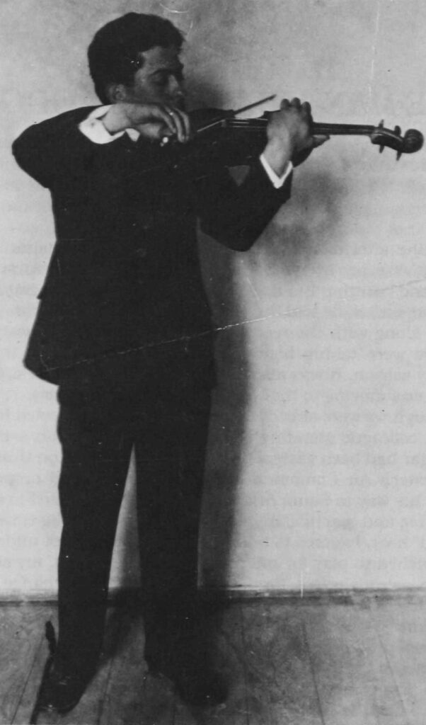 A man in a suit and tie holding something.