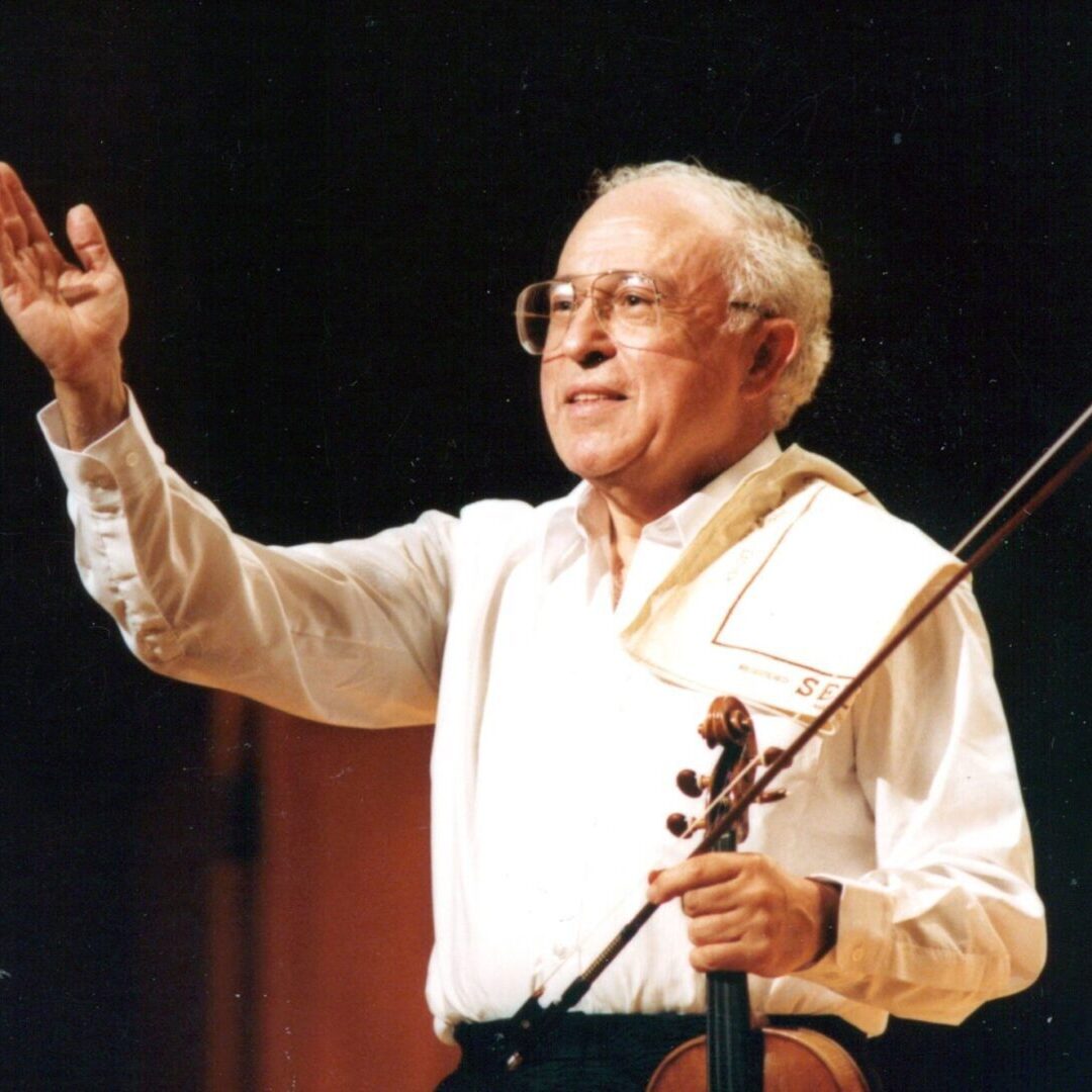 A man holding a violin in his hand.